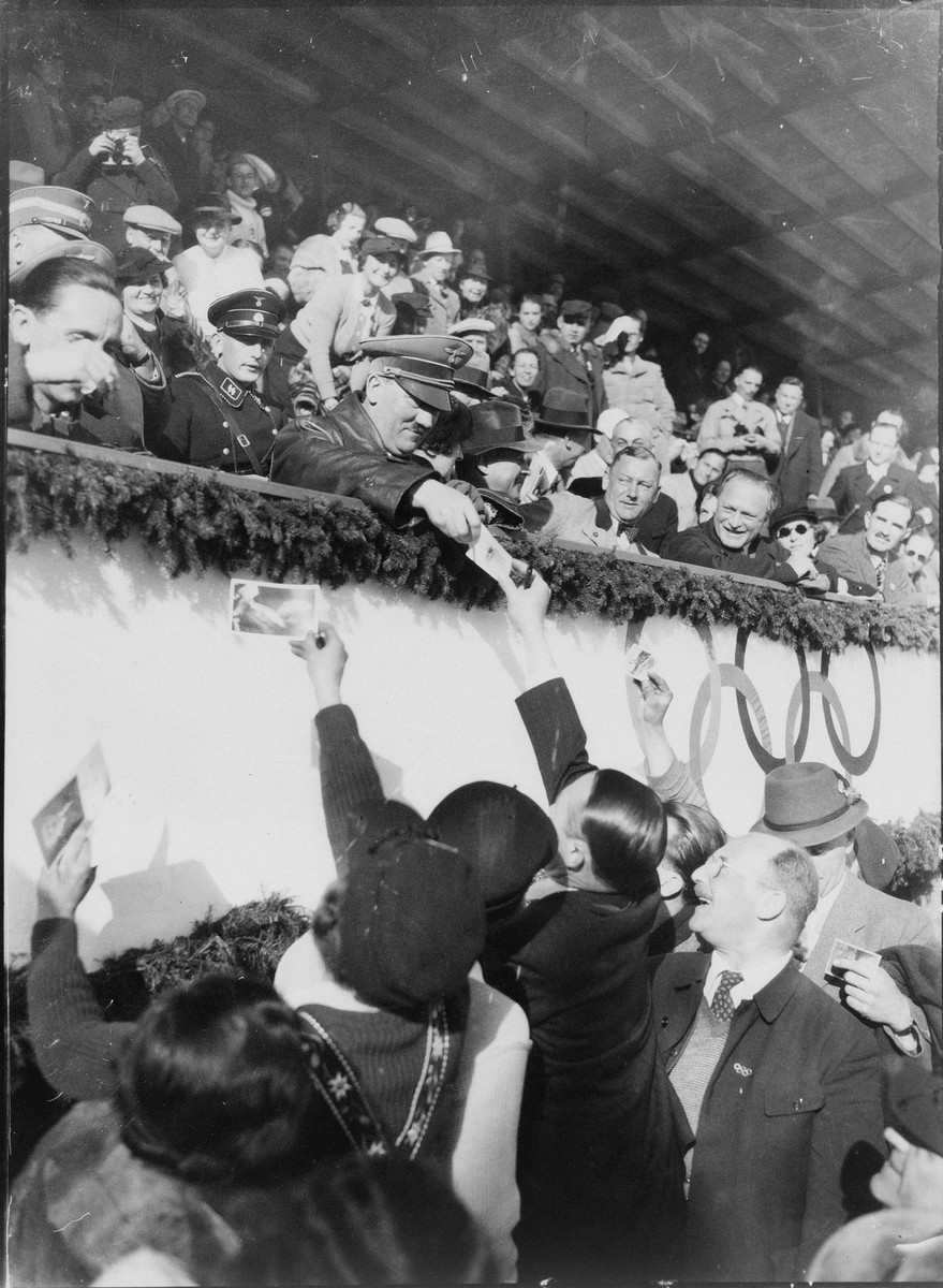 Adolf Hitler and Joseph Goebbels sign autographs on the occasion of the Hockey match between Canada and United States at the Winter Olympics